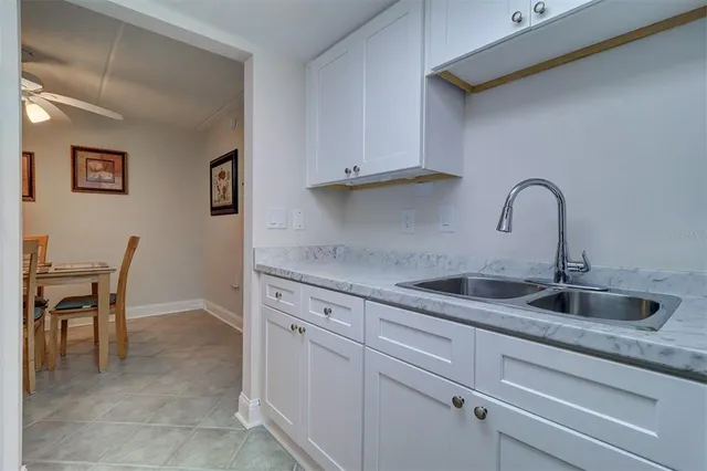 a kitchen with granite countertop a sink and cabinets