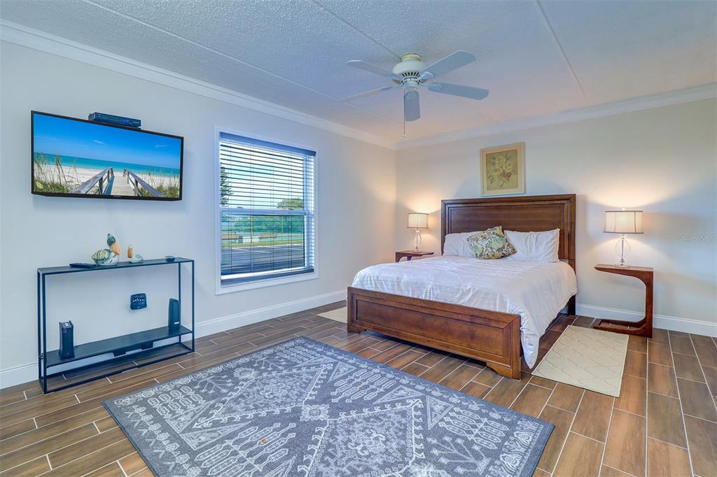 12760 Indian Rocks Road, Unit 1004 Largo, FL 33774 - Photo 17 of 45 a bedroom with a bed and a rug