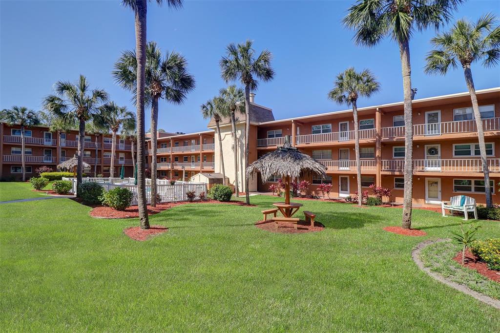 12760 Indian Rocks Road, Unit 1004 Largo, FL 33774 - Photo 27 of 45 a view of a backyard with a sitting area and slide
