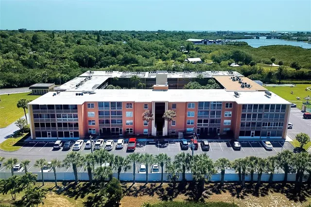 an aerial view of a house with a garden and lake view