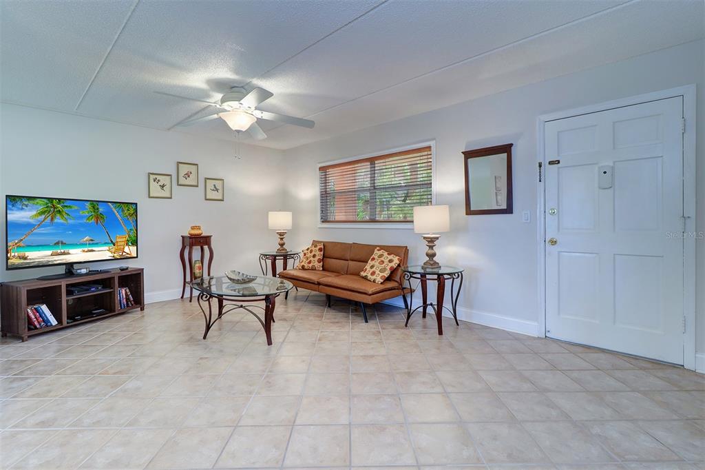 12760 Indian Rocks Road, Unit 1004 Largo, FL 33774 - Photo 6 of 45 a living room with furniture and a flat screen tv
