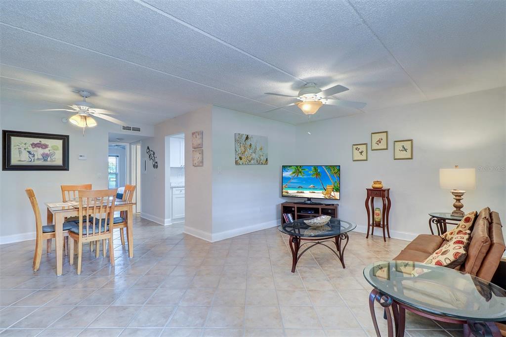 12760 Indian Rocks Road, Unit 1004 Largo, FL 33774 - Photo 7 of 45 a living room with furniture and a flat screen tv