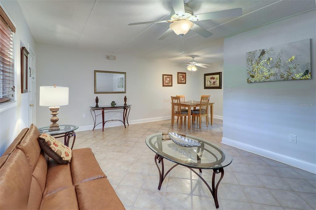 12760 Indian Rocks Road, Unit 1004 Largo, FL 33774 - Photo 9 of 45 a living room with furniture and a table