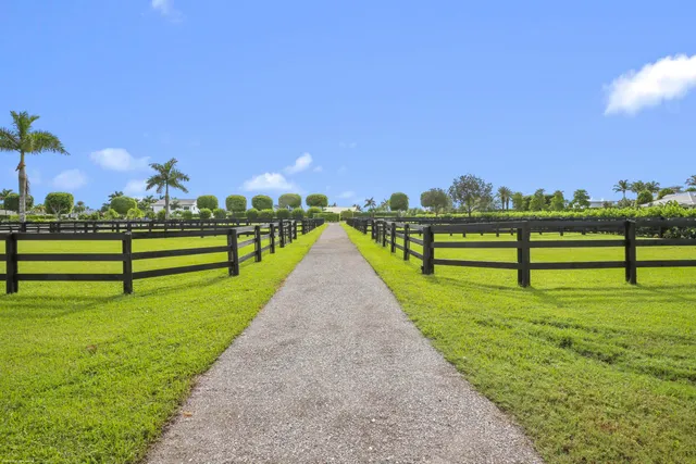 a view of a large swimming pool with an outdoor space and seating area