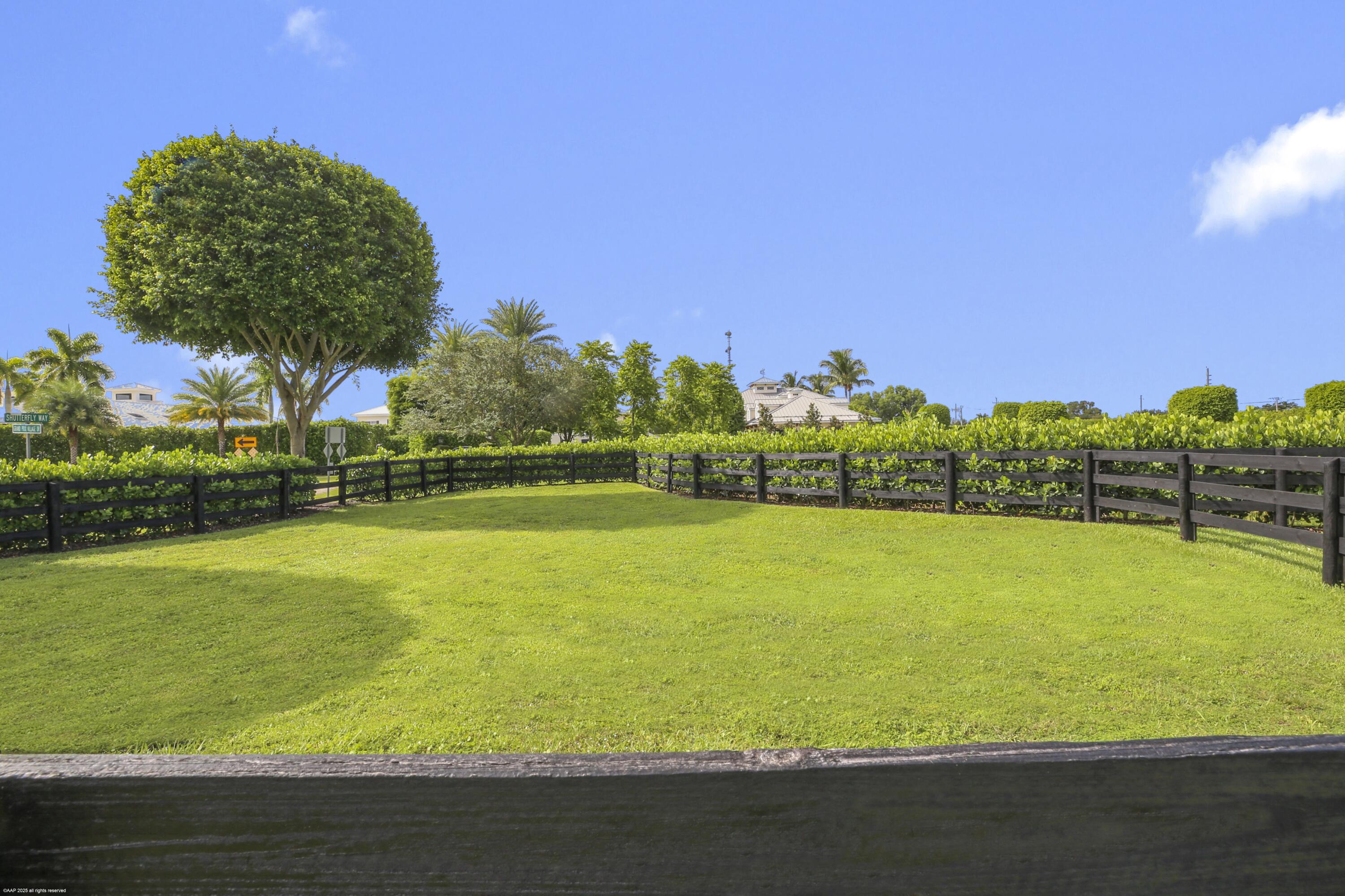 3899 Shutterfly Way Wellington, FL 33414 - Photo 7 of 27 a view of a large swimming pool with an outdoor space and seating area