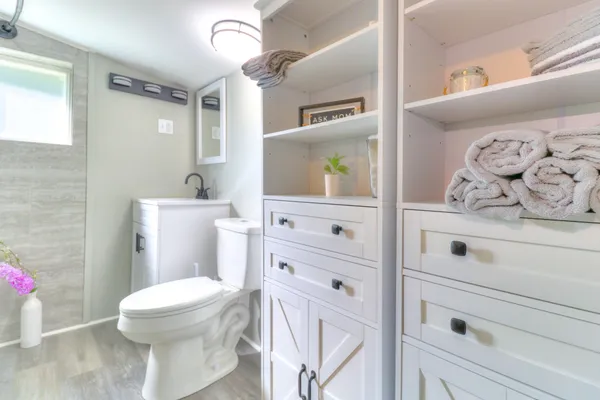 a bathroom with a sink a toilet and a mirror