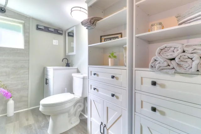 a bathroom with a sink a toilet and a mirror