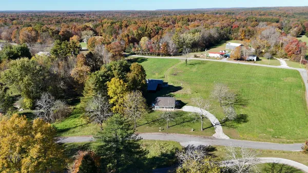 an aerial view of a houses with a yard