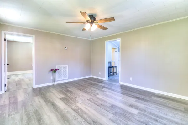 wooden floor in an empty room with a window