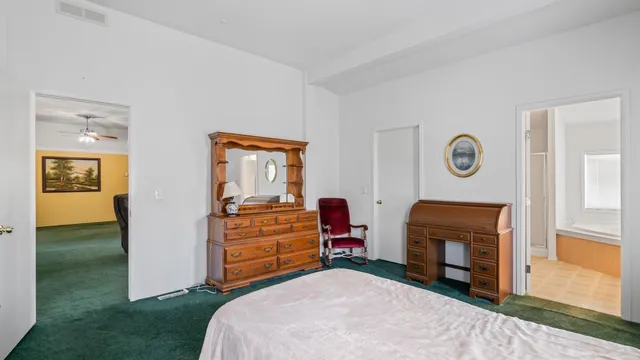 a bedroom with a bed and a dresser