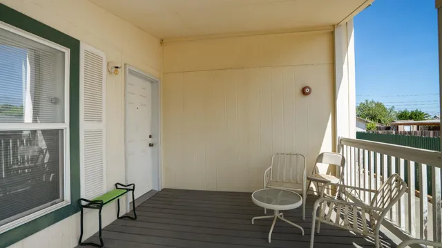a view of a room with wooden floor and chair
