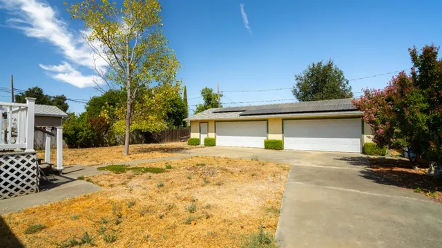 a yellow house with trees in front of it
