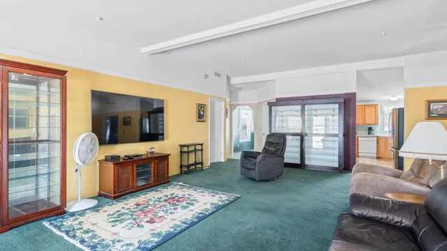 a living room with furniture windows and a wooden floor