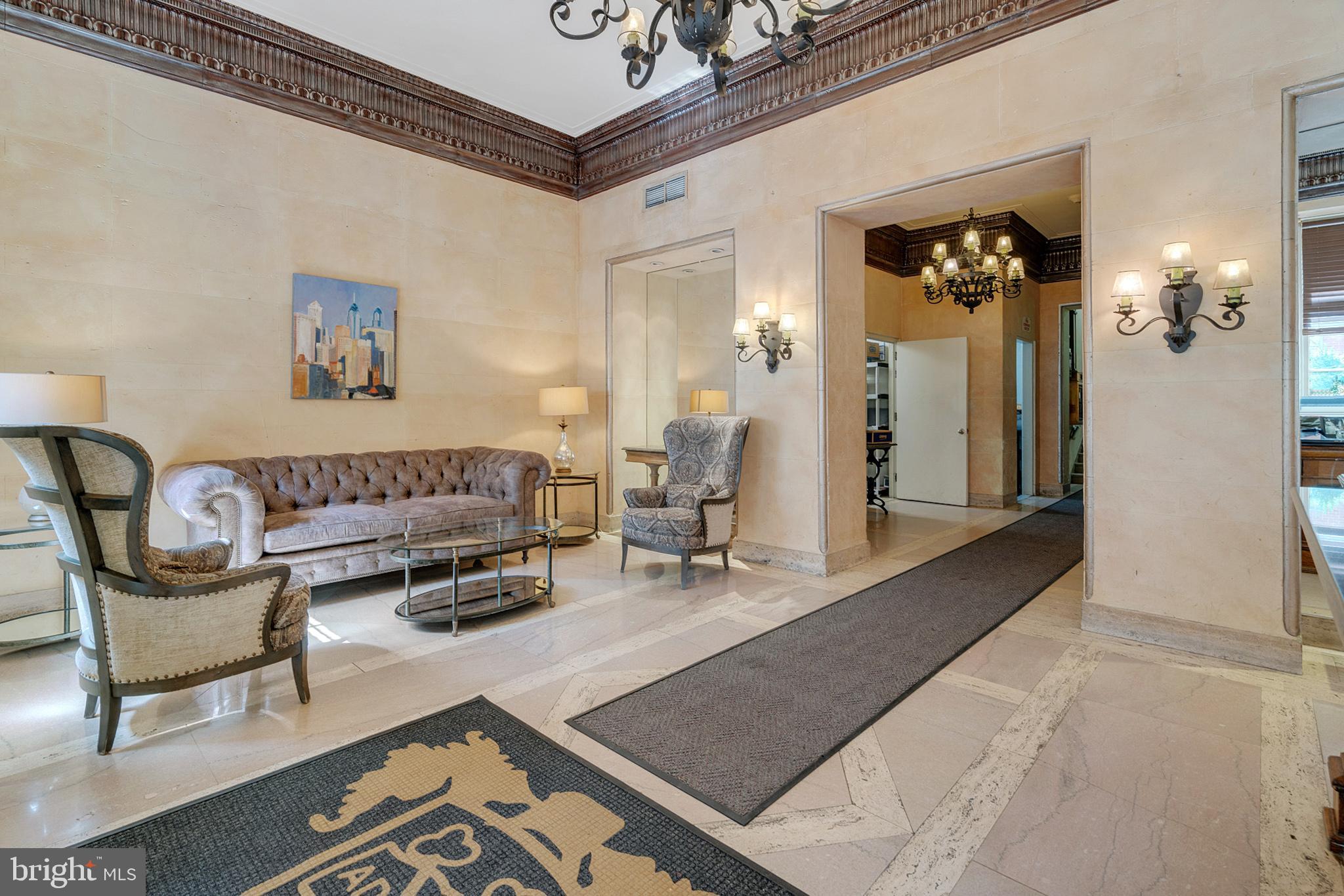 2031 Locust Street, Unit 405 Philadelphia, PA 19103 - Photo 11 of 13 a living room with furniture and a chandelier