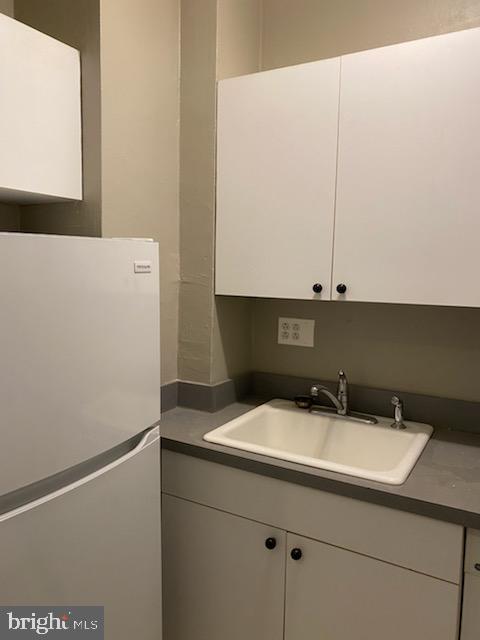 2031 Locust Street, Unit 405 Philadelphia, PA 19103 - Photo 3 of 13 a bathroom with a sink and a mirror