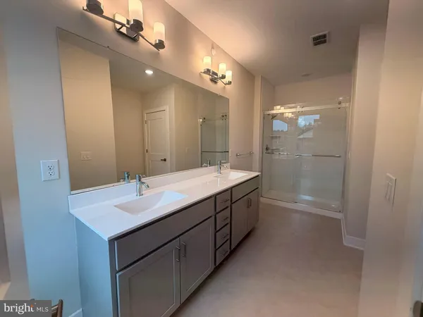 a kitchen with a sink and a mirror