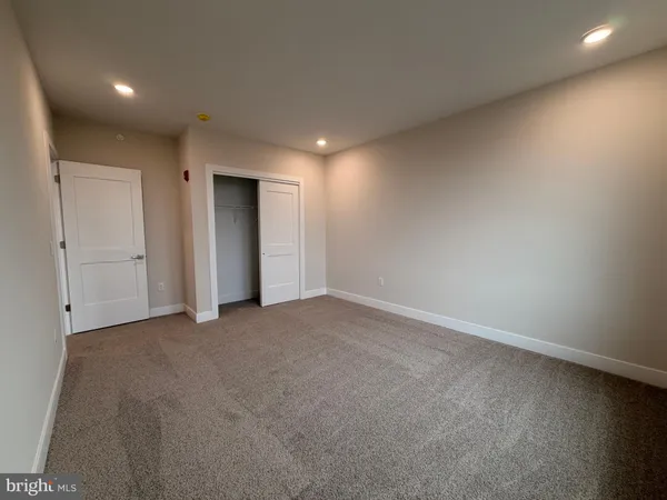 an empty room with windows and entrance