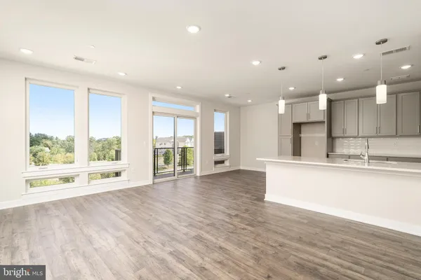 a view of kitchen with refrigerator sink and wooden floor