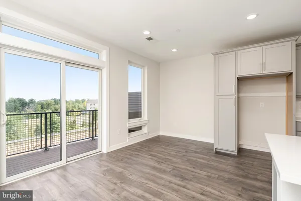 a kitchen with kitchen island a sink stainless steel appliances and refrigerator