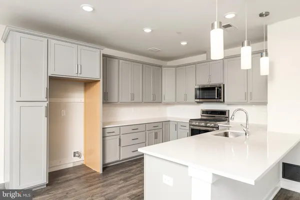 a kitchen with white cabinets stainless steel appliances and sink
