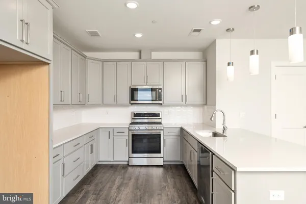 a view of a kitchen with a sink and a refrigerator