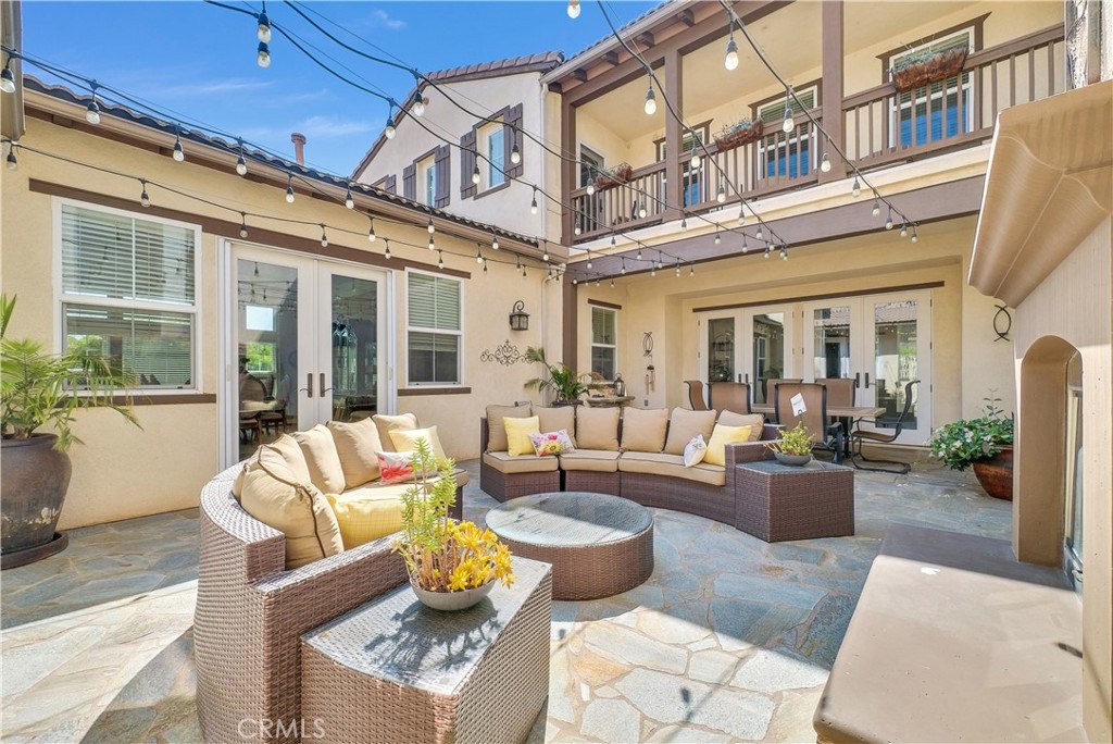 13123 Carriage Trail Court Rancho Cucamonga, CA 91739 - Photo 14 of 42 a view of a patio with couches table and chairs and potted plants