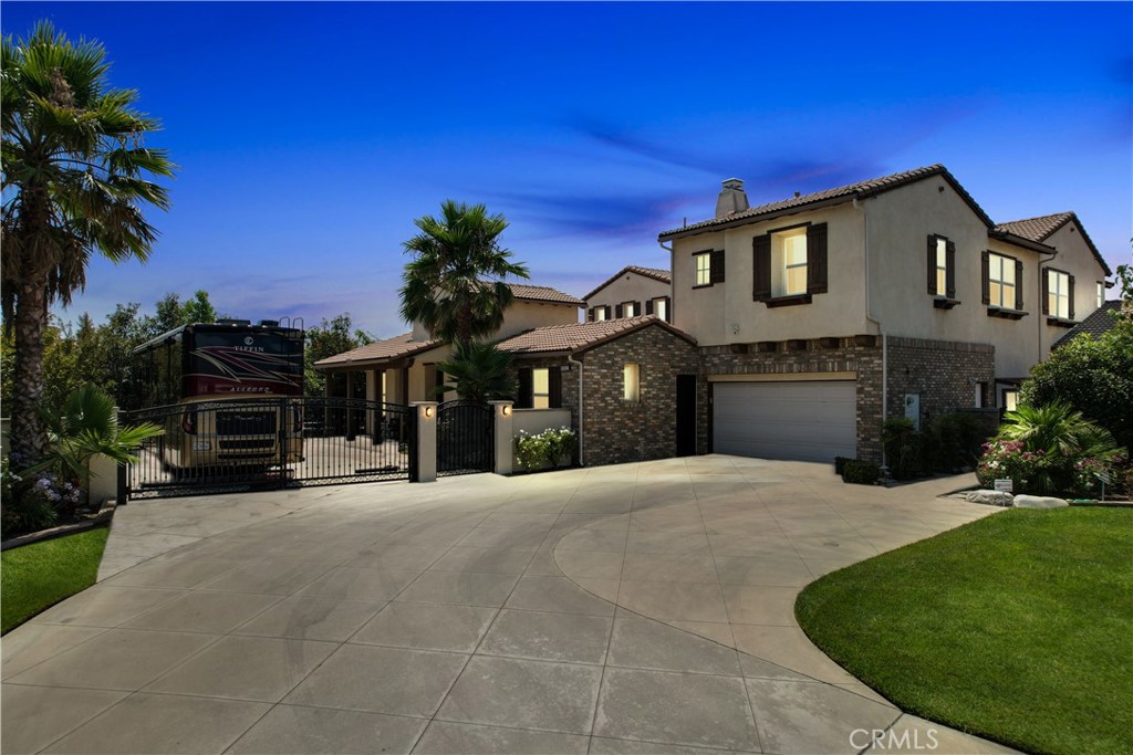 13123 Carriage Trail Court Rancho Cucamonga, CA 91739 - Photo 2 of 42 a front view of a house with a yard and garage
