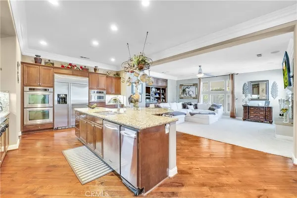 a kitchen with granite countertop a refrigerator and cabinets