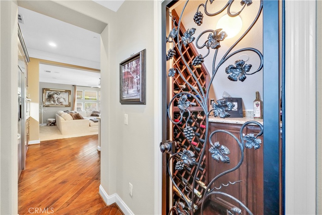 13123 Carriage Trail Court Rancho Cucamonga, CA 91739 - Photo 23 of 42 view of a hallway with wooden floor and a potted plant