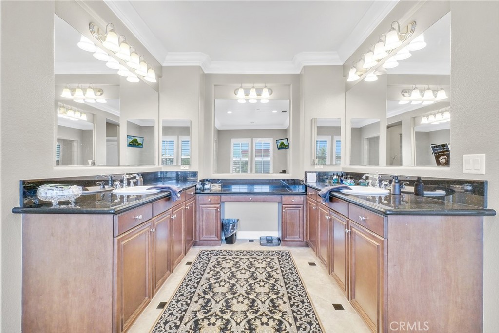 13123 Carriage Trail Court Rancho Cucamonga, CA 91739 - Photo 30 of 42 a large kitchen with stainless steel appliances granite countertop a sink and cabinets