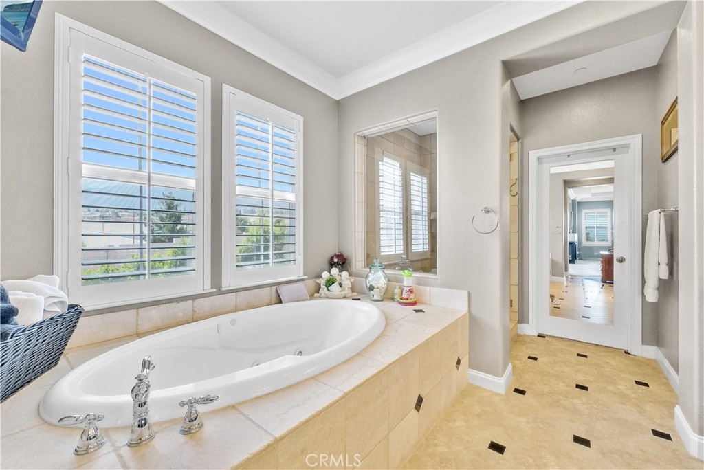 13123 Carriage Trail Court Rancho Cucamonga, CA 91739 - Photo 31 of 42 a bath tub sitting in a bathroom next to a window