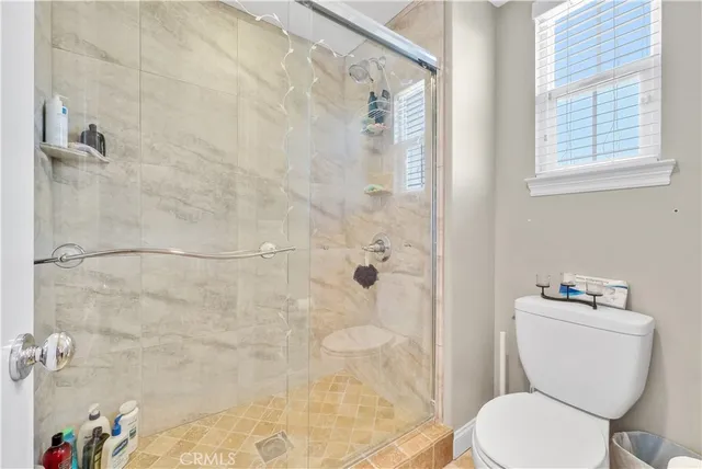 a bedroom with bed and a chandelier