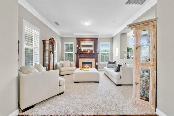 a living room with fireplace furniture and a table