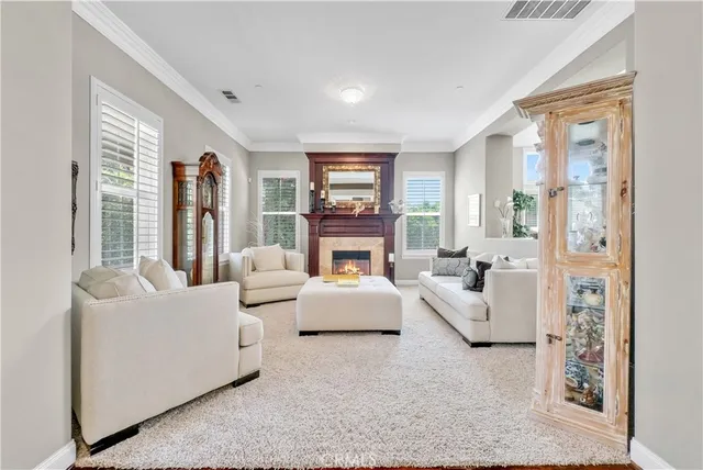 a living room with fireplace furniture and a table