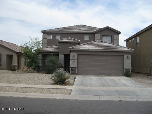 a front view of a house with a garden and garage