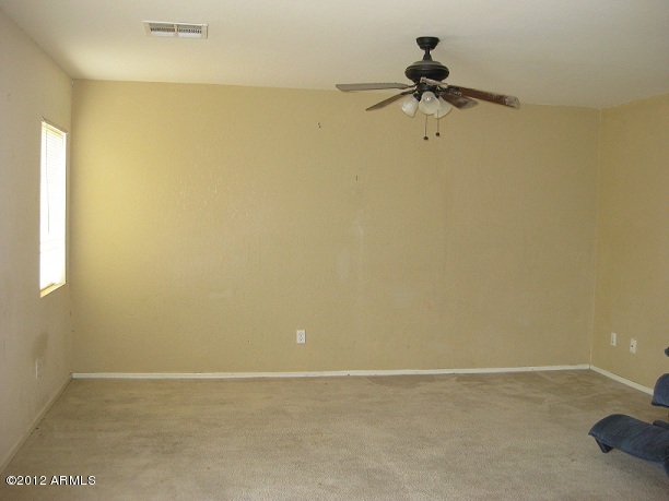 2849 East Bagdad Road San Tan Valley, AZ 85143 - Photo 13 of 17 a view of a room with a ceiling fan and a window