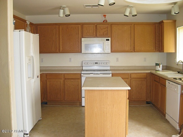 2849 East Bagdad Road San Tan Valley, AZ 85143 - Photo 4 of 17 a kitchen with a sink a stove and refrigerator