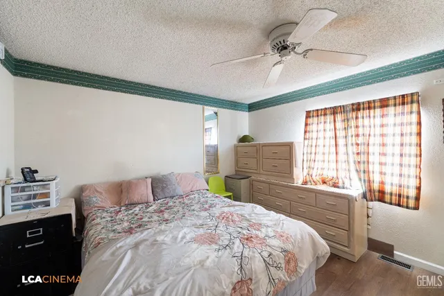 a bedroom with a bed dresser and a window