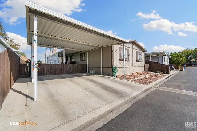 a view of a house with a wooden fence