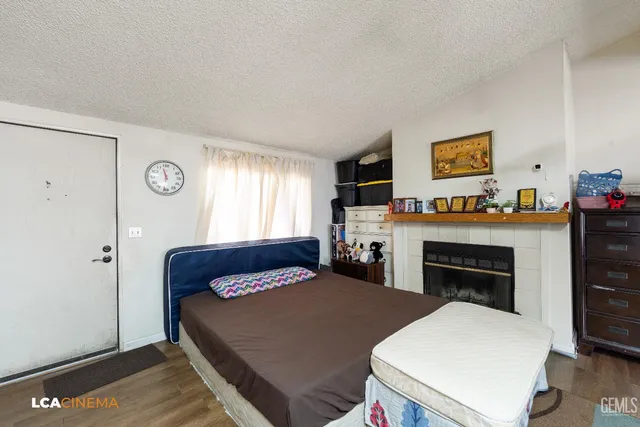 a bedroom with furniture and a fireplace