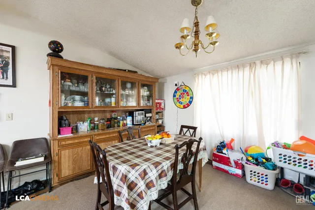 a dining room with furniture a rug and a chandelier