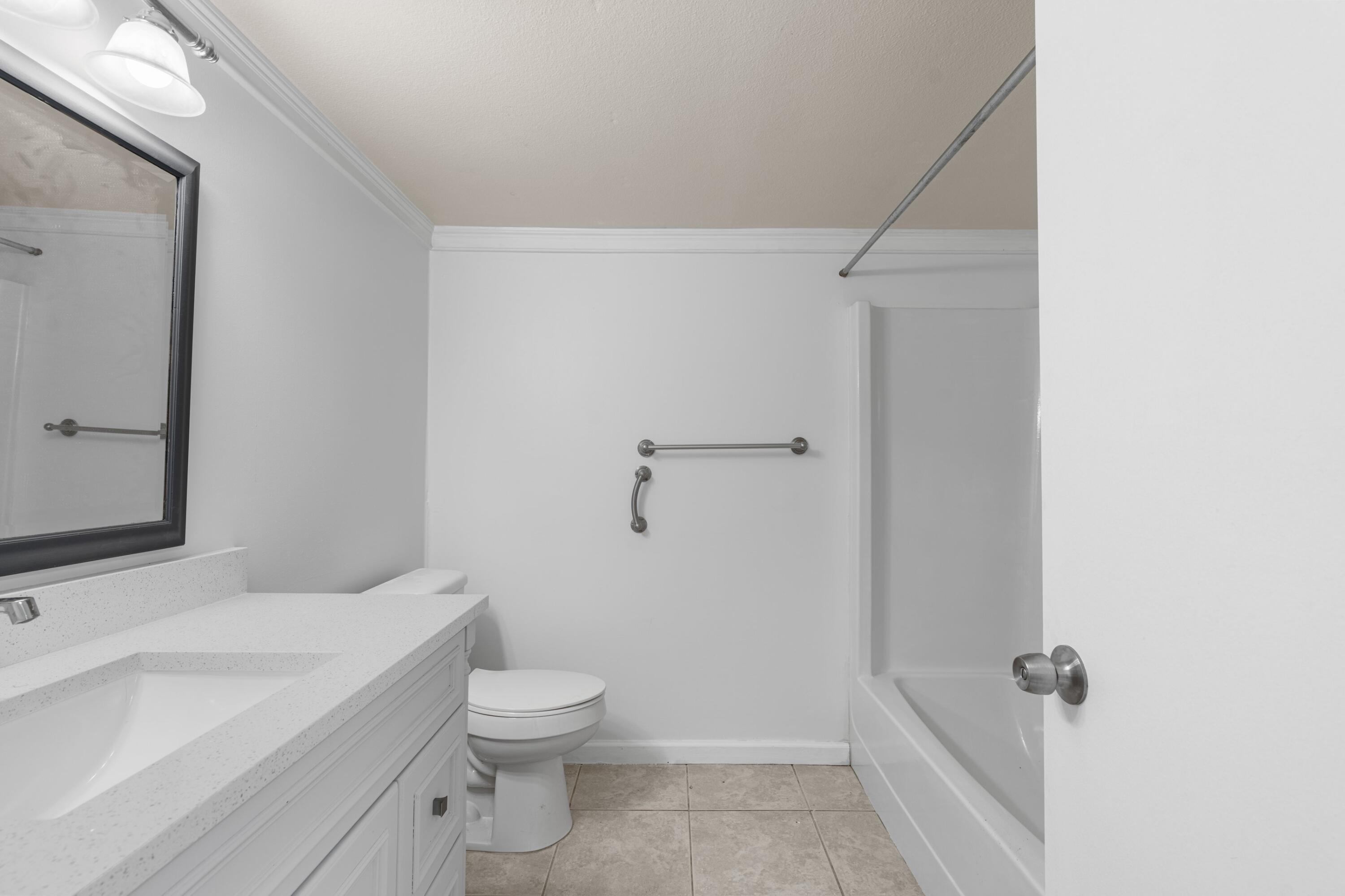 10693 North Military Trail, Unit 7 Palm Beach Gardens, FL 33410 - Photo 14 of 28 a bathroom with a sink a toilet and shower