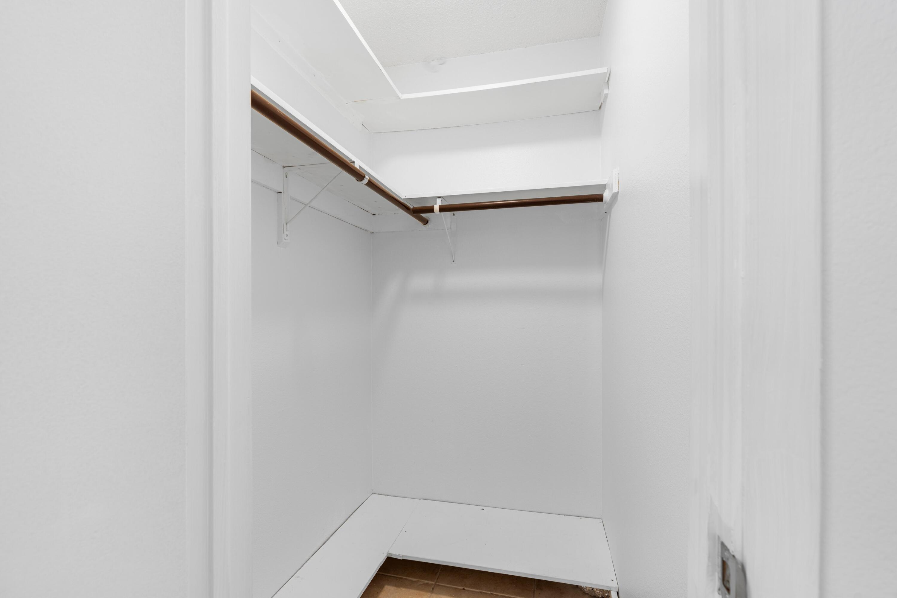 10693 North Military Trail, Unit 7 Palm Beach Gardens, FL 33410 - Photo 18 of 28 a view of walk in closet with empty racks