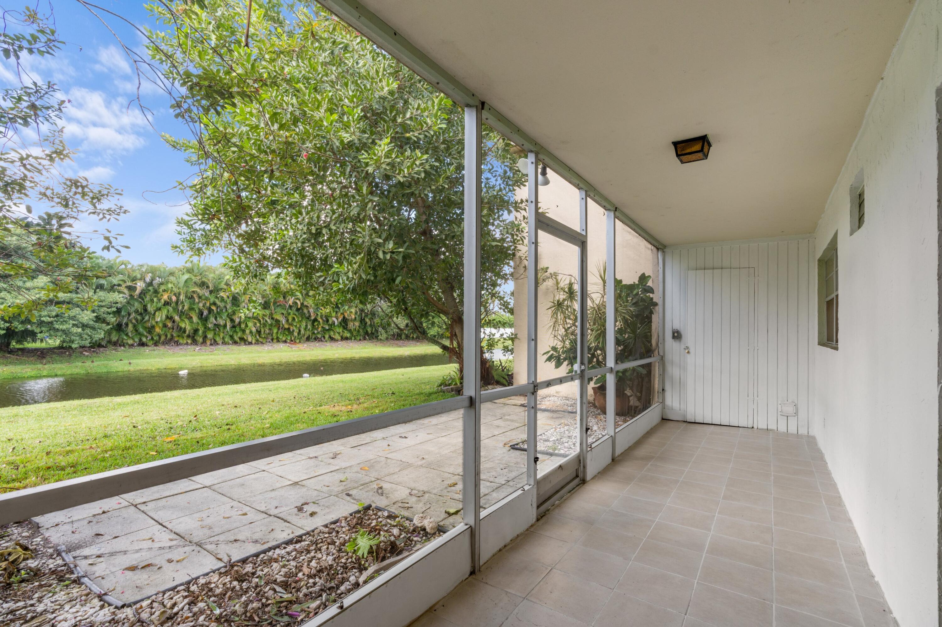 10693 North Military Trail, Unit 7 Palm Beach Gardens, FL 33410 - Photo 22 of 28 a view of a porch with an outdoor space