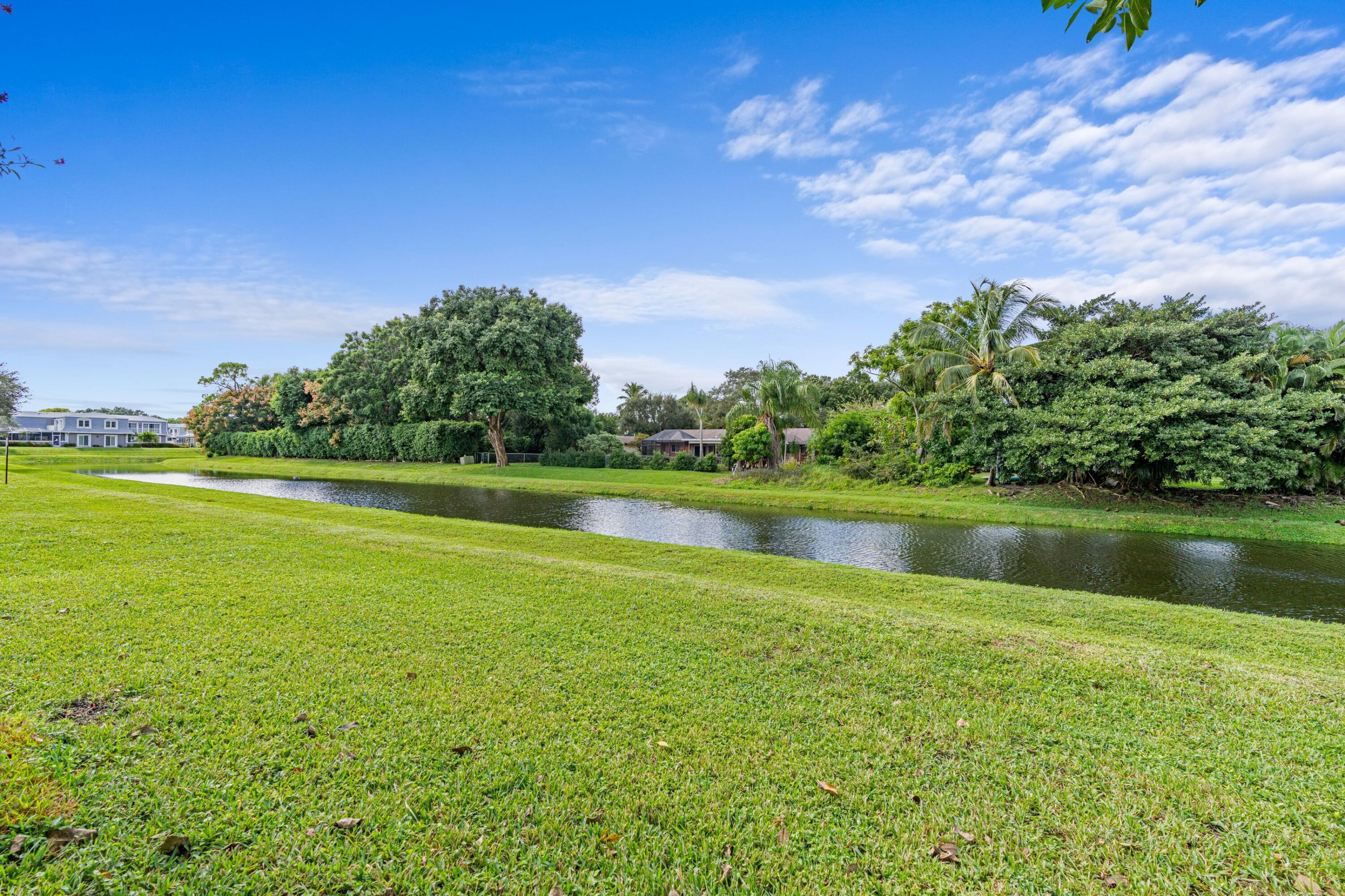 10693 North Military Trail, Unit 7 Palm Beach Gardens, FL 33410 - Photo 24 of 28 a view of a lake with a big yard