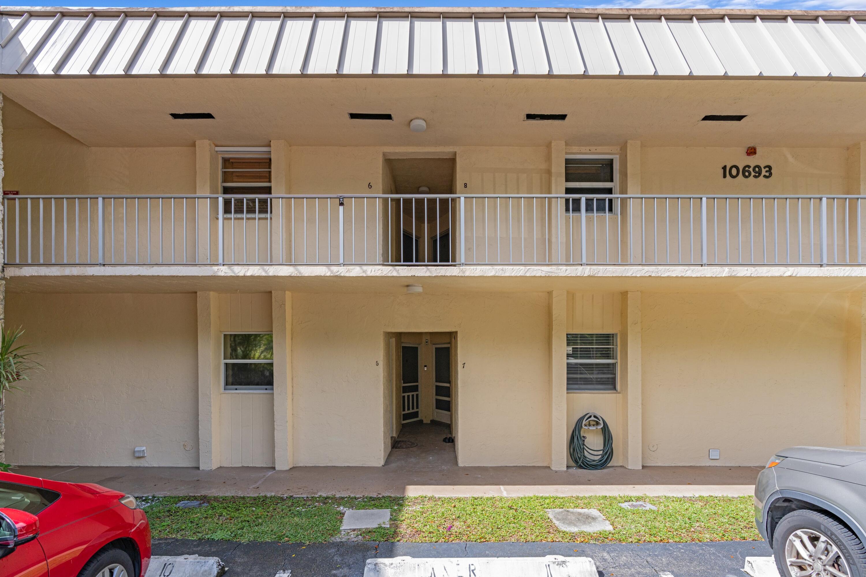 10693 North Military Trail, Unit 7 Palm Beach Gardens, FL 33410 - Photo 27 of 28 a front view of a house with a yard