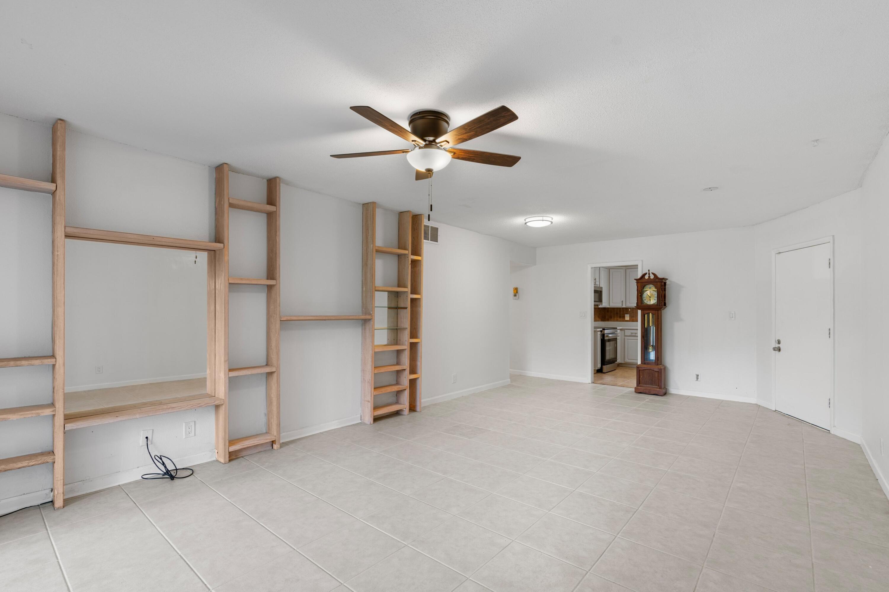 10693 North Military Trail, Unit 7 Palm Beach Gardens, FL 33410 - Photo 5 of 28 a view of an empty room with a ceiling fan