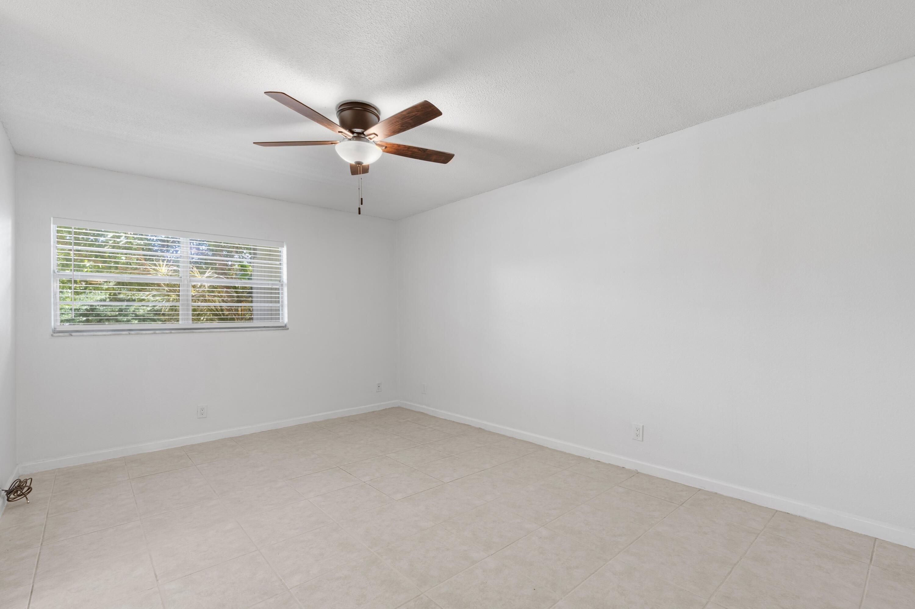 10693 North Military Trail, Unit 7 Palm Beach Gardens, FL 33410 - Photo 6 of 28 an empty room with a window and a fan