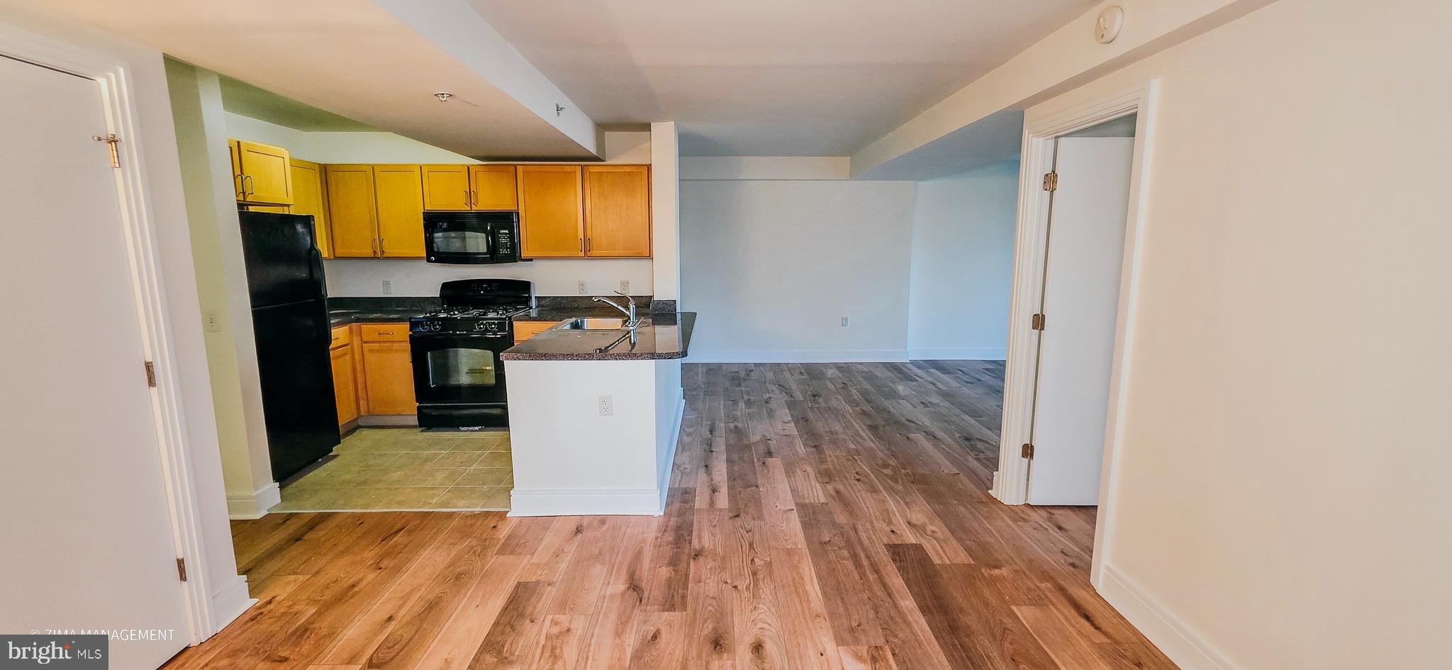 800 4th Street Southwest, Unit S402 Washington, DC 20024 - Photo 12 of 17 a view of a kitchen with wooden floor