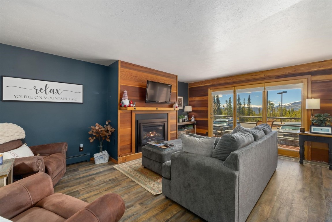 91200 Ryan Gulch Road, Unit 91204 Wildernest, CO 80498 - Photo 13 of 21 a living room with furniture a fireplace and a flat screen tv